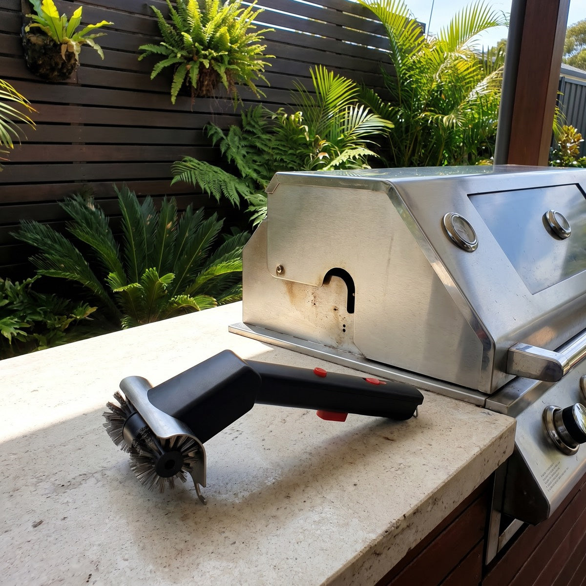 GRIZZLA Brush on the stone benchtop of a built-in BBQ