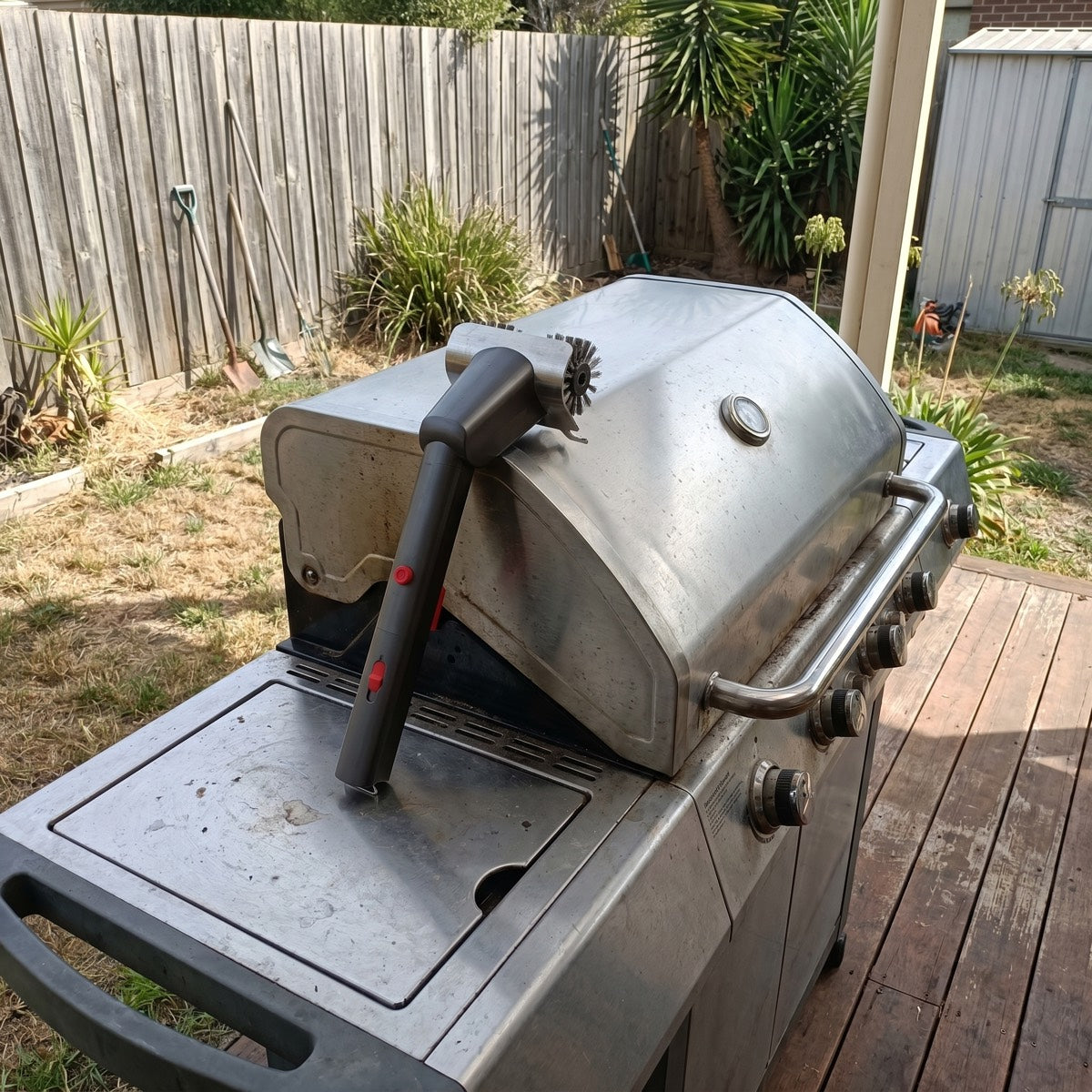 GRIZZLA Brush leaning against the BBQ after a cook